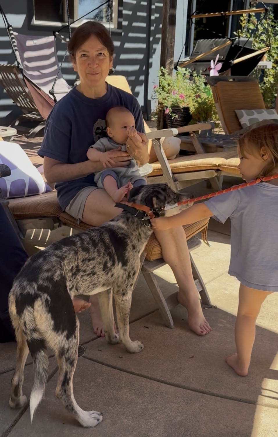 Young Arlo participating in family life with both sisters and their grandmother